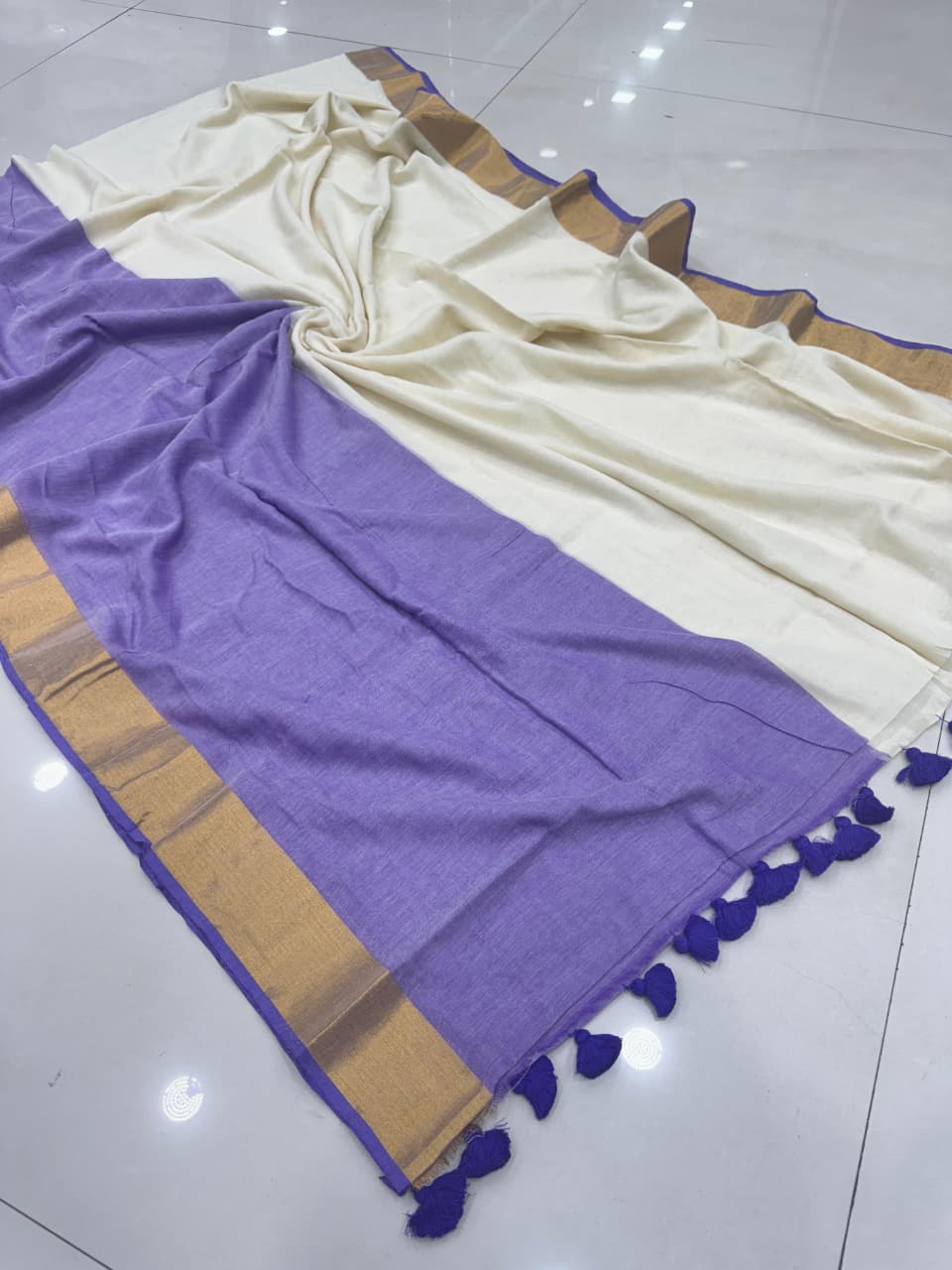 LAUK1694 Cream and lavender saree with golden zari border and tassel pallu